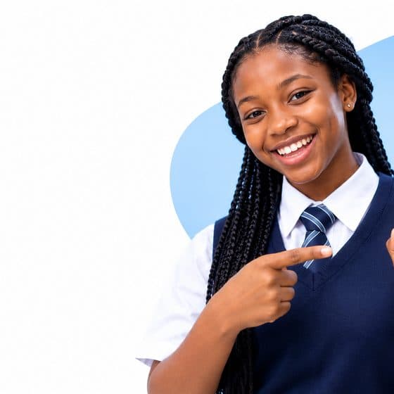 A student in uniform pointing at the Edmate app on a phone